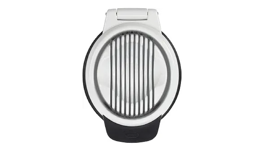 Stainless steel egg slicer cutting through a hard-boiled egg